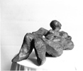 RECLINING WOMAN, Painted cement, 38cm (15in)
